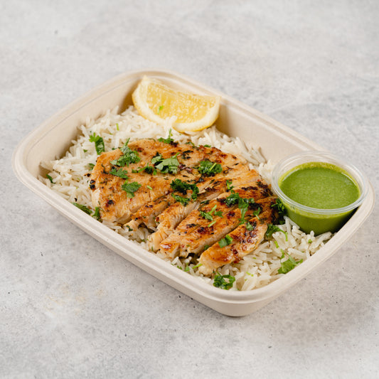 Body Building Meal Plan consisting of grilled chicken, white rice, and a side of green sauce, presented in a white take-out container. Fully Packed with proteins and controlled number of fats and calories, perfect for your body building goals.